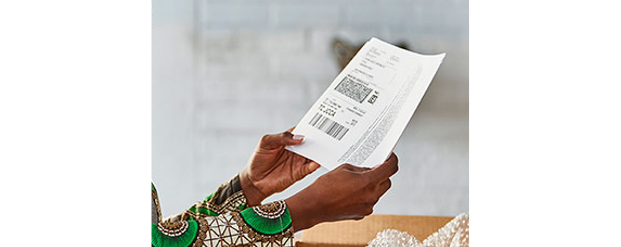 person holding a FedEx shipping Label